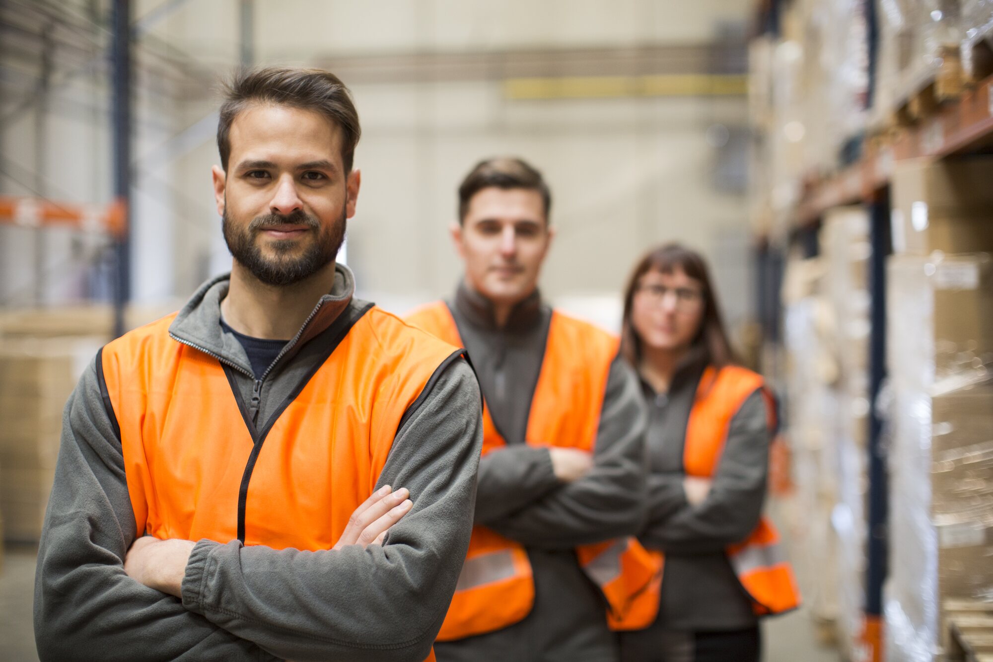 A warehouse team in hi-vis vests standing together on the floor